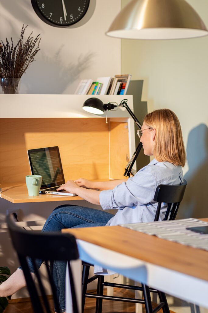 Remote worker using a laptop in a home office, complying with 2026 OECD tax residency guidelines.